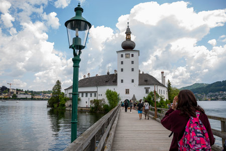 Gmunden , Austria - June 17, 2023: Orth Castle and Kissing Bridge on Lake Traunsee in Gmundenのeditorial素材