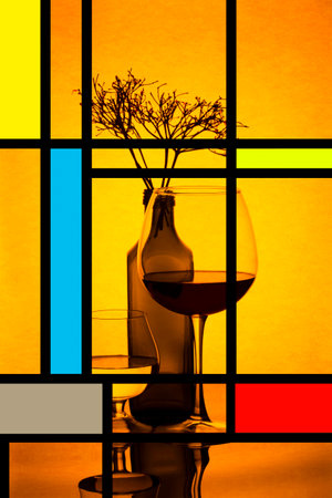 Still life with colored glass bottles and plant twigs and abstract figuresの写真素材