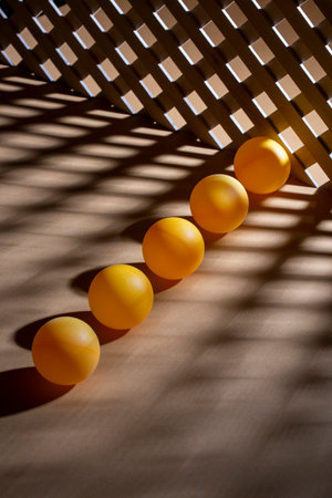 Abstract background with wooden grid and orange ballsの写真素材
