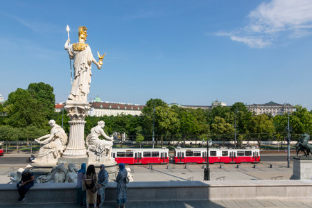 Vienna, Austria - June 19, 2023: Sculpture of Pallas Athena with a fountain in front of the Austrian Parliament buildingのeditorial素材