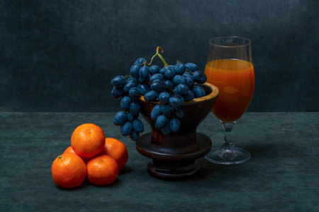 Still life with tangerines, grapes and orange juiceの写真素材