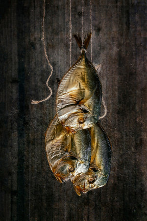 Three smoked sea fish Selene close-up on a string
