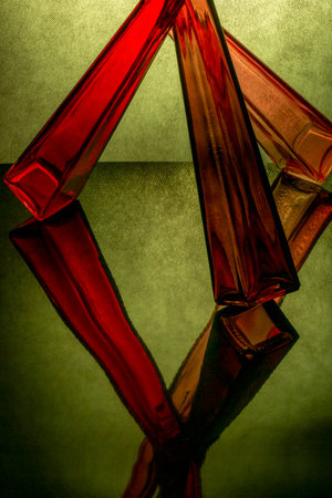 Abstract composition of glass objects on a reflective surface