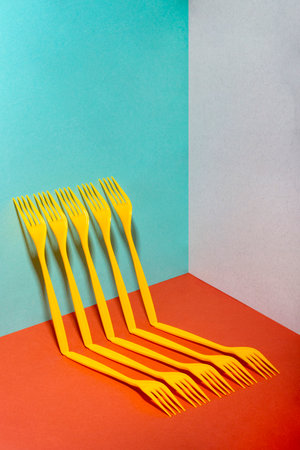 Abstract still life with yellow forks on a colorful background