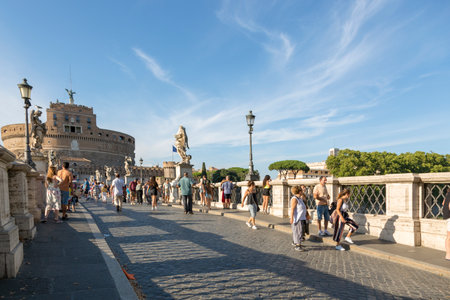 Rome, Italy - August 16, 2019: People on the bridge of the Holy Angel on the background of the...