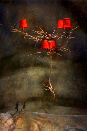 Surreal picture of a tree with red buckets and a man and a woman walking along the road