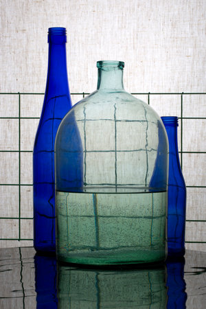 Still life with blue bottles and a jar with water