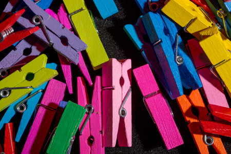 A background of many colorful wooden clothespins.