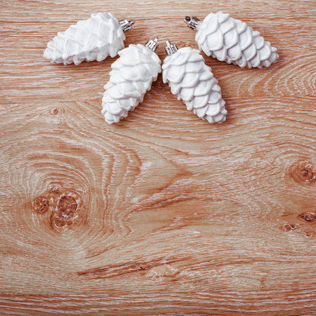 White and silver Christmas ornaments on a rustic wooden background. Xmas card. Happy New Year. Top view with copy spaceの写真素材