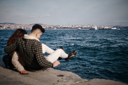 A couple in love celebrates their engagement on the seashore in Istanbulの写真素材