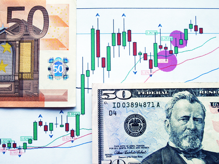 Money laying on the table of an exchange rate of currency.    の写真素材