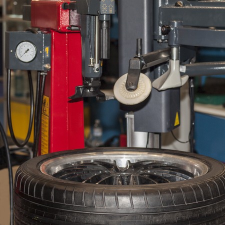 Car tyre service and tire with wheel balancing on white backgroundの写真素材