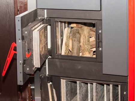 The loading door is solid fuel boiler with pallets for ignitionの写真素材