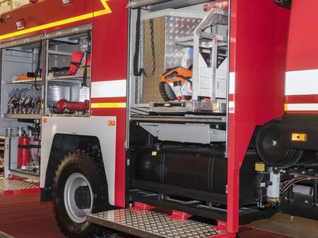 An open fire engine with the necessary equipment and tools. Side view