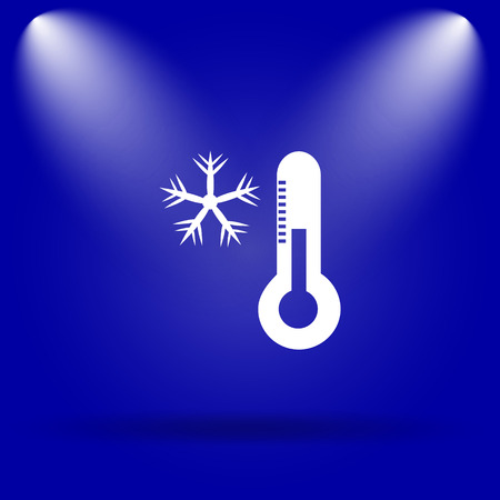Snowflake with thermometer icon. Flat icon on blue background.の写真素材