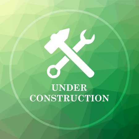 Under construction icon. Under construction website button on green low poly background.の写真素材