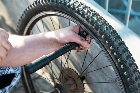 A man pumps bicycle wheel