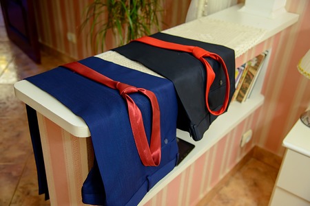 Blue and black pants with a red tieの写真素材