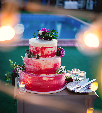 Red festive cake with flowers. Wedding cake.の写真素材