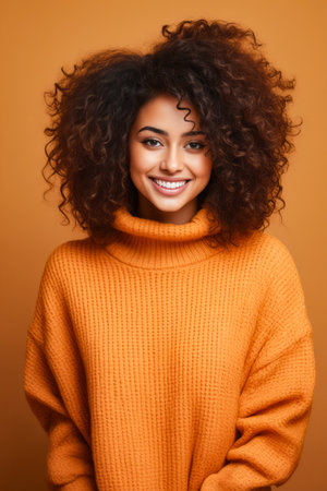 Woman with bright orange sweater and curly hair smiling. Generative AI.の素材
