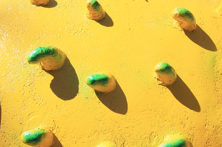 old yellow decorative wall stucco texture at sun lightの写真素材