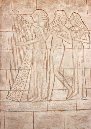 Old murals. Frieze of Egyptian Goddess. Wall carving