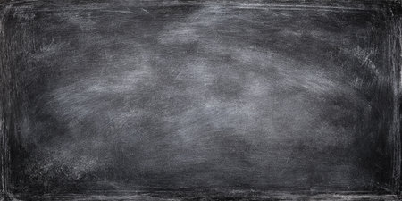 A grunge black chalkboard with visible chalk dust and smudges, creating a textured and slightly faded appearance. Concept related to education, learning, messages, creativity, and vintage aestheticsの素材