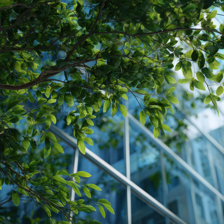 A contemporary glass building adorned with vibrant green plants and surrounded by trees, showing a harmonious blend of modern architecture and natural elements, promoting sustainable urban development and eco-conscious design.の素材