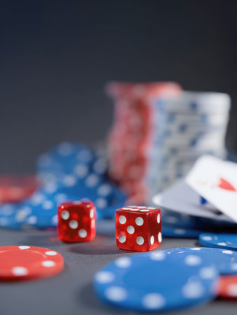 Two red dice showing five and six surrounded by red and blue poker chips and playing cards, set against a dark, moody background. A high-stakes visual representing gambling, casino games, luck, and risk management.の素材