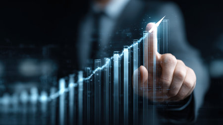 Close-up of a businessman interacting with a blue, abstract digital interface showing an exponential growth chart, representing successful investment, profit gain, positive forecasts, innovation, and utilizing big data for corporate strategy.の素材