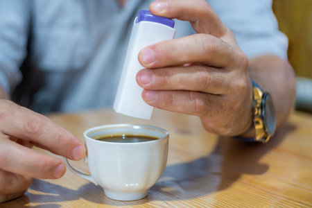 a man adds sweetener to coffee instead of sugar