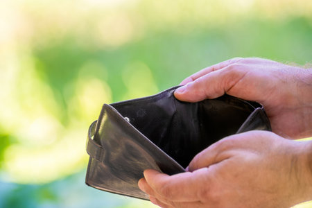 in the hands of a person an empty wallet, the concept of poverty, unemploymentの写真素材