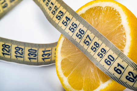citrus fruit wrapped with a soft meter-long ribbon on a white background