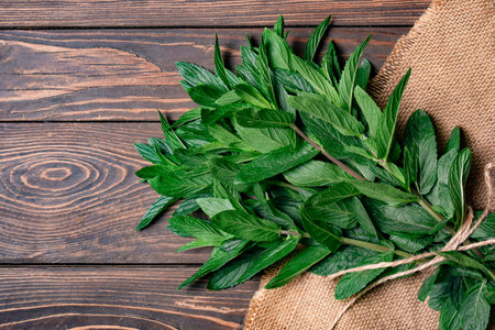 Fresh mint leaves on wooden background. Top view. Copy space.の写真素材