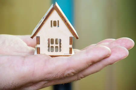 House model in human hand. Real estate and property investment concept.の写真素材