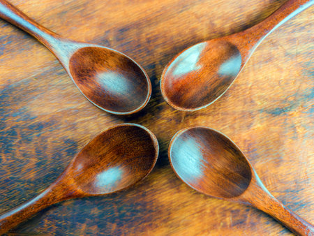 Wooden spoons on a wooden background. View from above.の写真素材