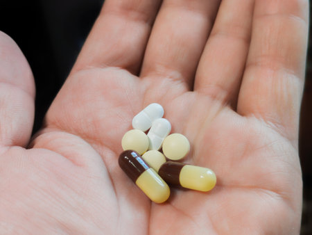 Pills in a woman's hand. Close-up. Selective focus.の写真素材