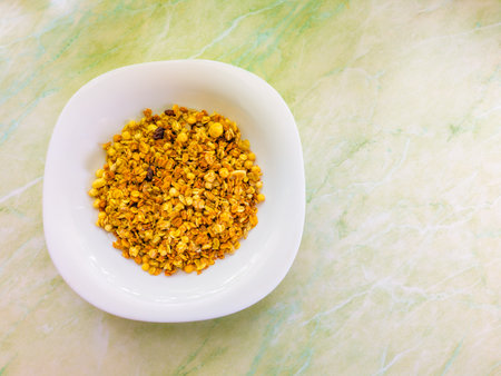 Bowl full of pistachios on green marble backgroundの写真素材