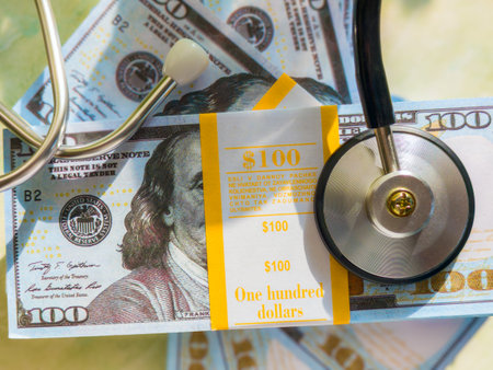 Stethoscope and 100 dollar banknote as medical cost concept.の写真素材