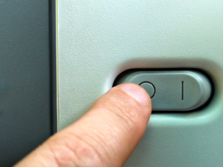 Close up of a finger pressing the button on the door handle.