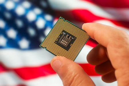 Close up of cpu microprocessor in human hand on american flag background