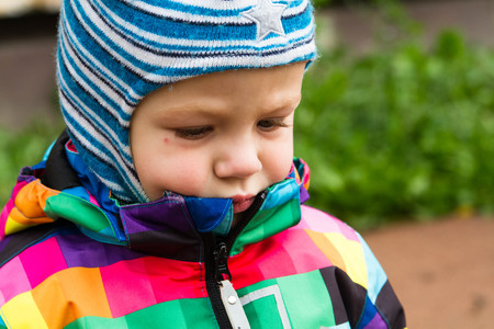 a little boy walking on the street