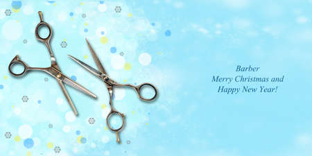 Barber scissors on a blue background. Snowflakes. Multi-colored glare. Happy New Year hairdresser. Congratulatory banner for Hairdressers, Beauty Salons, Barbershop. Christmas background.の写真素材