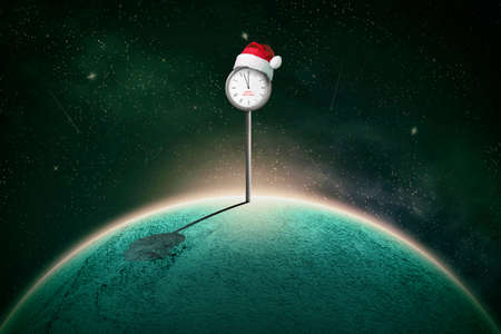 Street clock, with hands at 12, in a Santa hat, on a planet in space. Abstract New Year card. Festive background.の写真素材