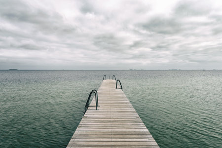 Wooden pier leading to the sea. Baltic Sea, Copenhagen. Denmark. Freedom. Trips Lifestyleの写真素材