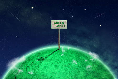 Abstract green planet in the cosmic sky with a wooden sign. Green planet word. Abstract ecological background. Background.の写真素材