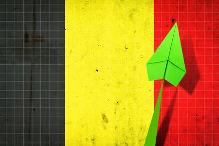 Upward arrow on the background of the flag of Belgium. Paper plane. Economic recovery. Copy space.3D illustration. Business.の写真素材