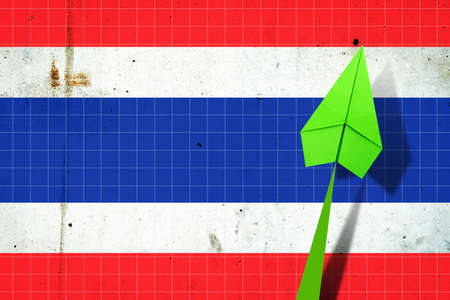 Upward arrow on the background of the flag of Thailand. Paper plane. Economic recovery. Copy space.3D illustration. Business.の写真素材