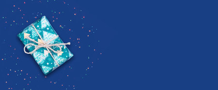 New Year's gift on a blue background. New year banner. Copy space. Place for text. Festive background. Background.の写真素材