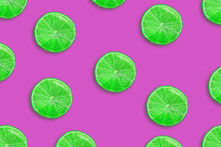 Sliced juicy lime on a purple background. Fresh fruit. Fruit background. Summer Party.Birthday.Bright Colorful.の写真素材